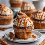 Churro cupcakes topped with cinnamon-sugar and cream cheese frosting, perfect festive dessert for holiday gatherings.