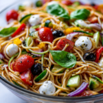 Delicious Italian Spaghetti Salad Recipe Vibrant Italian Spaghetti Salad with fresh vegetables and Italian dressing, perfect for potlucks and holiday gatherings.