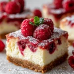 Raspberry cheesecake bars with graham cracker crust, vibrant raspberries, and creamy filling, perfect holiday dessert