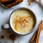 Delicious oat milk honey latte made with brewed coffee and warm oat milk, perfect for cozy autumn afternoons. Homemade festive latte drink.