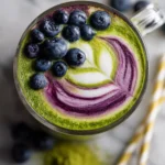 A vibrant Blueberry Matcha Latte topped with fresh blueberries, perfect for holiday gatherings, rich in antioxidants, and quick to prepare.